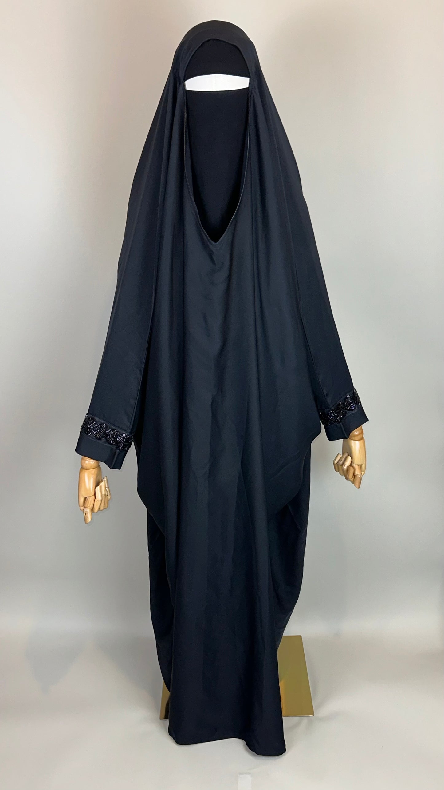 Black khimar and niqab set on mannequin, beaded cuffs, modest Islamic clothing display