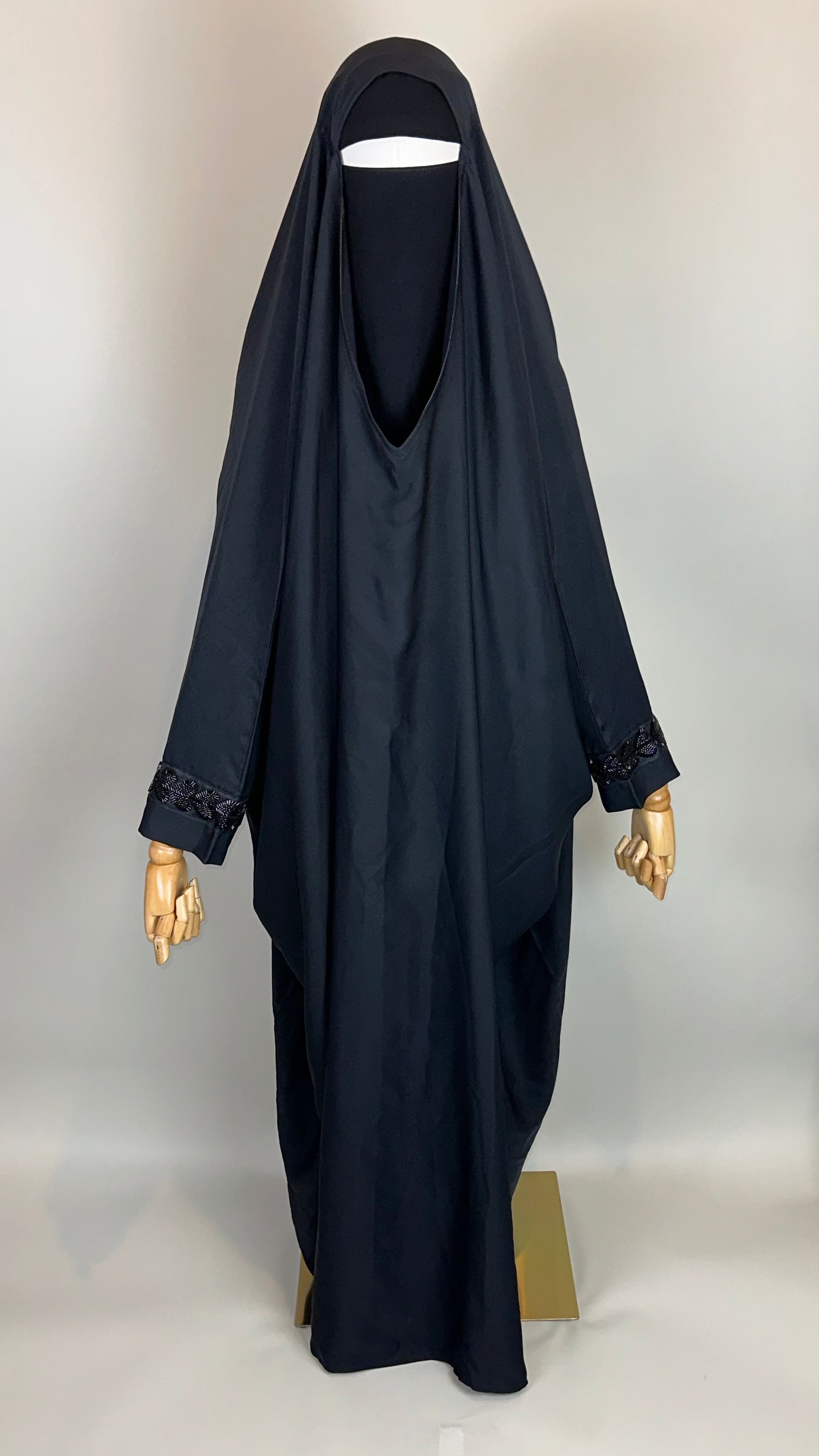 Black khimar and niqab set on mannequin, beaded cuffs, modest Islamic clothing display