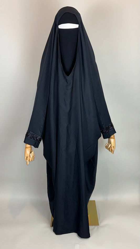 Black khimar and niqab set on mannequin, beaded cuffs, modest Islamic clothing display