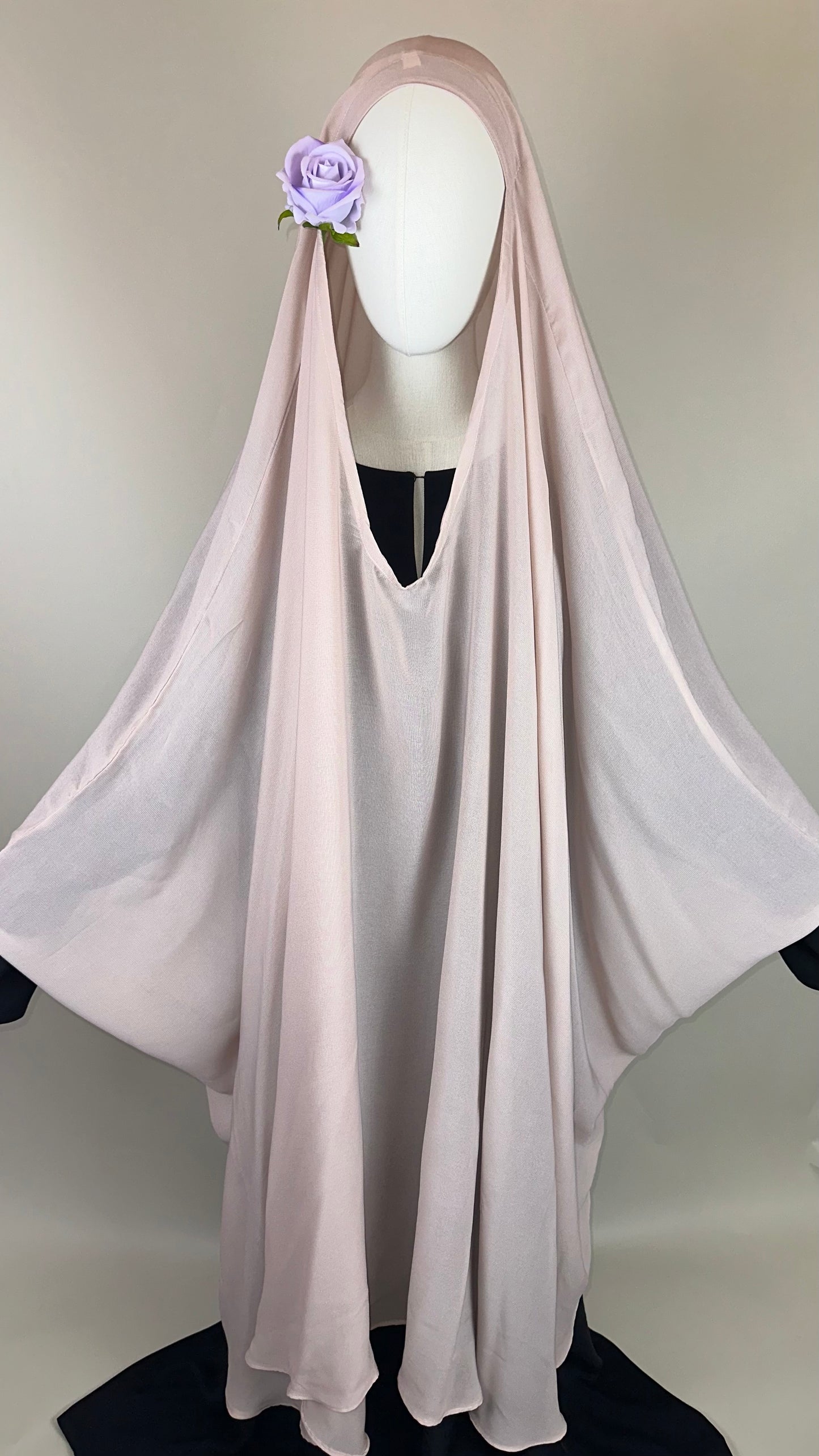 Light pink khimar with lavender flower accent on mannequin, modest Islamic fashion