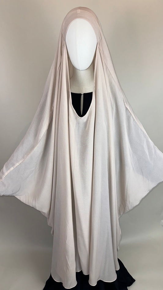 Ivory khimar abaya on mannequin, modest Islamic clothing, draped in soft fabric