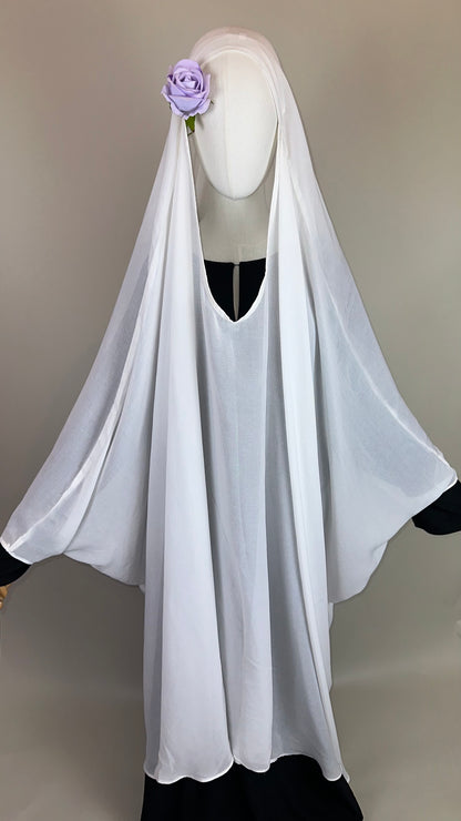 White Islamic khimar on mannequin with lilac flower, modest fashion display