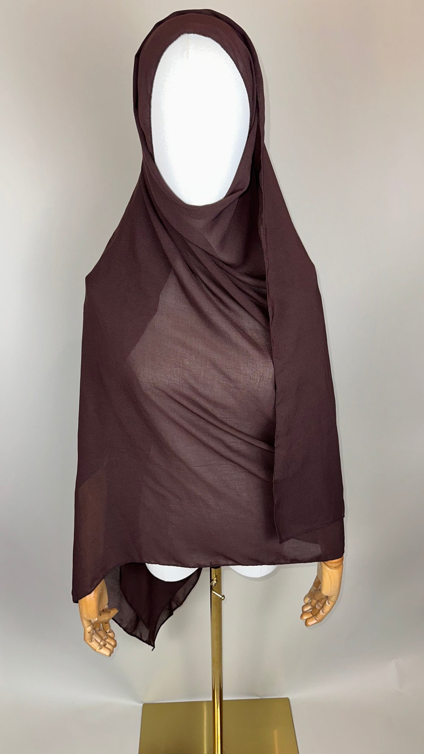 Brown chiffon hijab on mannequin with neutral background
